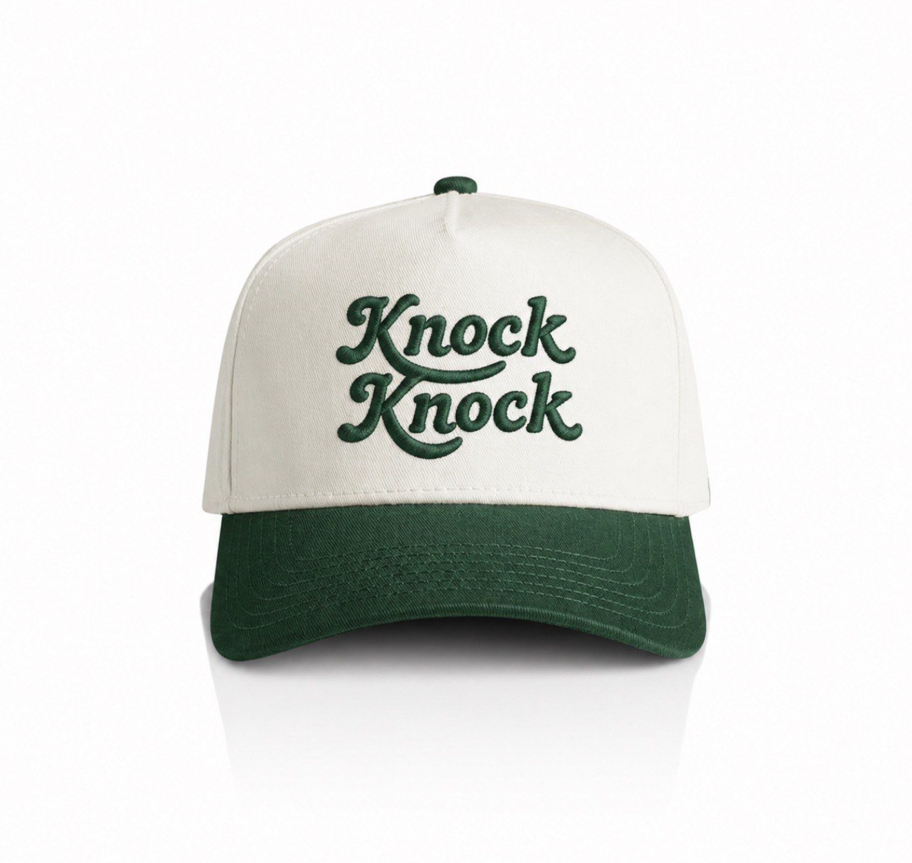 Cream and green trucker cap with an embroidered script wordmark