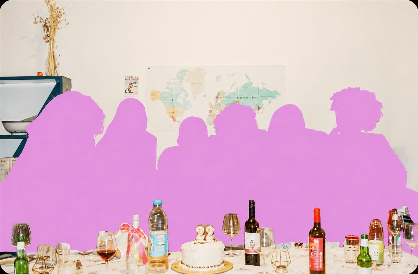 A team dinner table with a birthday cake and bottles